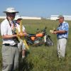 Mr. Rubber Power Herb Kothe winds for a mass launch attempt.  That's Don DeLoach as his able mechanic.  WWII Low Wing Military Trainer mass launch event.