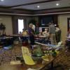 Judging area at Comfort Inn with kit vendors in the background.  Lee Cambell is under the mirror and Roger Willis is enjoying a coockie on the left.