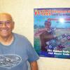 SCAMPS own Fernando Ramos poses with his sponsor poster-artwork by Duke Horn for all sponsors