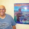 SCAMPS own Fernando Ramos poses with his sponsor poster-artwork by Duke Horn for all sponsors