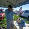 Tom Arnold looking for the dime he sez fell into his model. P-63 racer that flew well