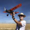 Wally Farrell holds his Travelair 6000 for the camera while making motor sounds. Beautiful model and flies well. Took an uncharacteristic dive to the mat during the mass launch.