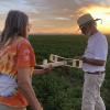 Wally Farrell winds his Voisin while Julie holds. Golden Hour flying as the sun sets. No wind out there that evening.