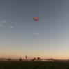 Mike Kelly's Waco flies during Golden Hour. Discovery that skiis will toe down creating air brake effect discovered that evening.