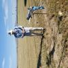 Tom Arnold winding his T-28. Note the dismal and scraggly field on one side of the road versus the thick alfalfa on the other side. Not very forgiving stuff.